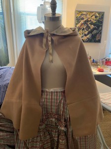 a snuff colored wool cloak on a female mannequin