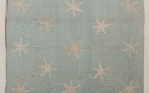 thirteen six pointed stars on a faded blue background